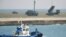 A Patriot Advanced Capability-3 missiles unit (R) is seen as a boat sails past in Ishigaki on Japan's southern island of Ishigaki Island, Okinawa prefecture, December 10, 2012.