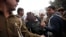 Police officials escort an accused in the gang rape of a 51-year-old Danish tourist to produce him in court in New Delhi, India, Jan. 16, 2014.
