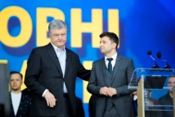 FILE - Ukrainian President Petro Poroshenko, left, and Ukrainian presidential candidate Volodymyr Zelenskiy attend debates at the Olympic stadium in Kiev, Ukraine, April 19, 2019.