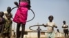 FILE - Children play with hula hoops at the Children Friendly Space, run by UNICEF at the United Nations Missions in South Sudan (UNMISS) Protection of Civilians site, in Juba, South Sudan, Jan. 15, 2016.