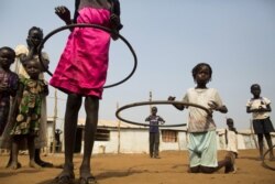 FILE - Children play with hula hoops at the Children Friendly Space, run by UNICEF at the United Nations Missions in South Sudan (UNMISS) Protection of Civillians (PoC) site, in Juba, South Sudan, Jan. 15, 2016.