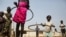 FILE - Children play with hula hoops at a UNICEF site in Juba, South Sudan, on Jan. 15, 2016. A new program to bring teenage mothers back to school is helping the country address the gender gap in education, experts say.