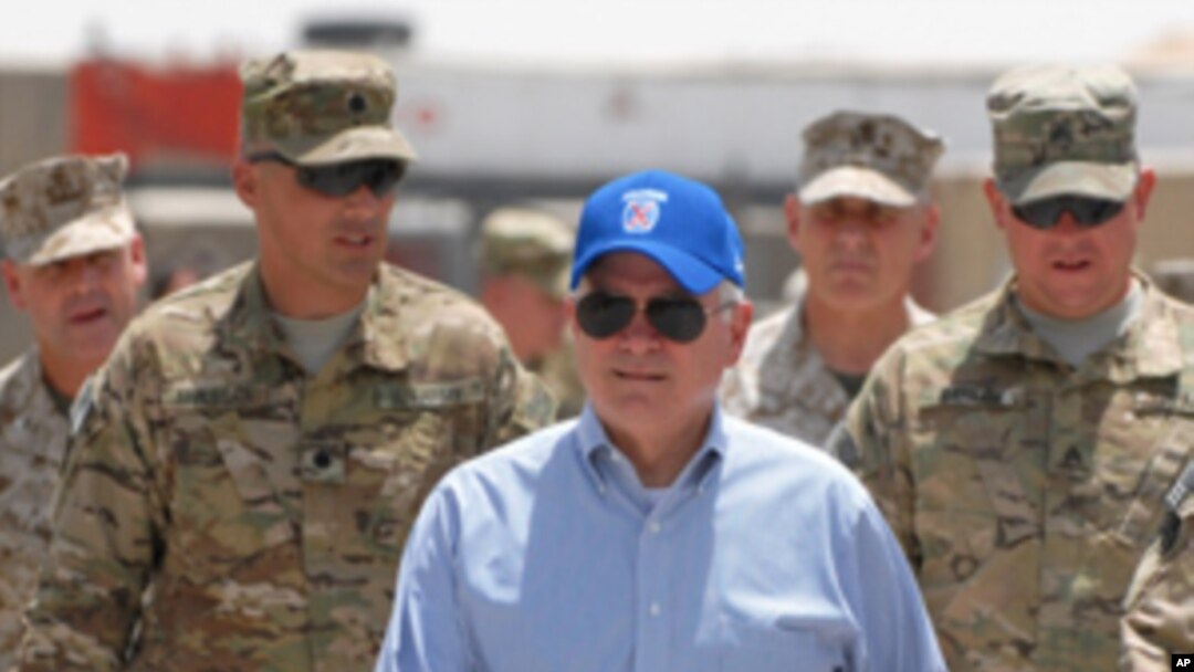 U.S. Secretary of Defense Robert M. Gates walks with a group of service members at Forward Operating Base Waltman, Sunday, June 5, 2011, in Kandahar, Afghanistan