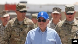 U.S. Secretary of Defense Robert M. Gates walks with a group of service members at Forward Operating Base Waltman, Sunday, June 5, 2011, in Kandahar, Afghanistan.