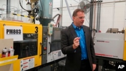 FILE - Chief financial officer Paul Buzzell explains the process of making levels, at the Johnson Level and Tool plant, in Mequon, Wisconsin, Sept. 12, 2018. Tariffs which the Trump administration imposed on Chinese goods could cost the company an estimated $3.7 million annually, Buzzell said.