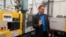 FILE - Chief financial officer Paul Buzzell explains the process of making levels, at the Johnson Level and Tool plant, in Mequon, Wisconsin, Sept. 12, 2018. Tariffs which the Trump administration imposed on Chinese goods could cost the company an estimated $3.7 million annually, Buzzell said.
