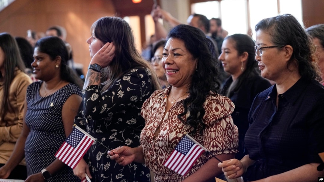 FILE - Women take part in a naturalization ceremony, March 8, 2024, in San Antonio. More than half the U.S. foreign-born population lives in just four states — California, Texas, Florida and New York — a Census Bureau report released in April 2024 said.