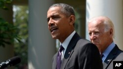 President Barack Obama, accompanied by Vice President Joe Biden, speaks in the Rose Garden of the White House in Washington, July 1, 2015. 