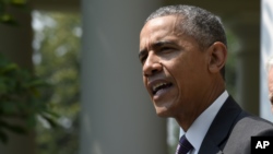 President Barack Obama, accompanied by Vice President Joe Biden, speaks in the Rose Garden of the White House in Washington, July 1, 2015. 
