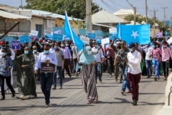Somalis march and protest against the government and the delay of the country's election in the capital Mogadishu, Somalia, Feb. 19, 2021.