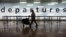 A passenger arrive at Glasgow International Airport as flights resume as the ash cloud from the Eyjafjallajokull volcano in Iceland continues to disrupt air travel throughout Europe, April 20, 2010.