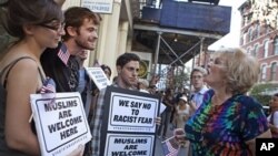 Linda Jacknow, 70, of Long Island, N.Y., right, an opponent of the proposed Islamic center and mosque to be built near Ground Zero argues against Aviva Stampfer, 21, of Manhattan, N.Y., left, and Blake Luley, 23, of Brooklyn, N.Y., both in favor of the p