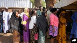 People queue to cast their votes during the presidential and parliamentary elections in Yola, Nigeria, Saturday, Feb. 25, 2023.