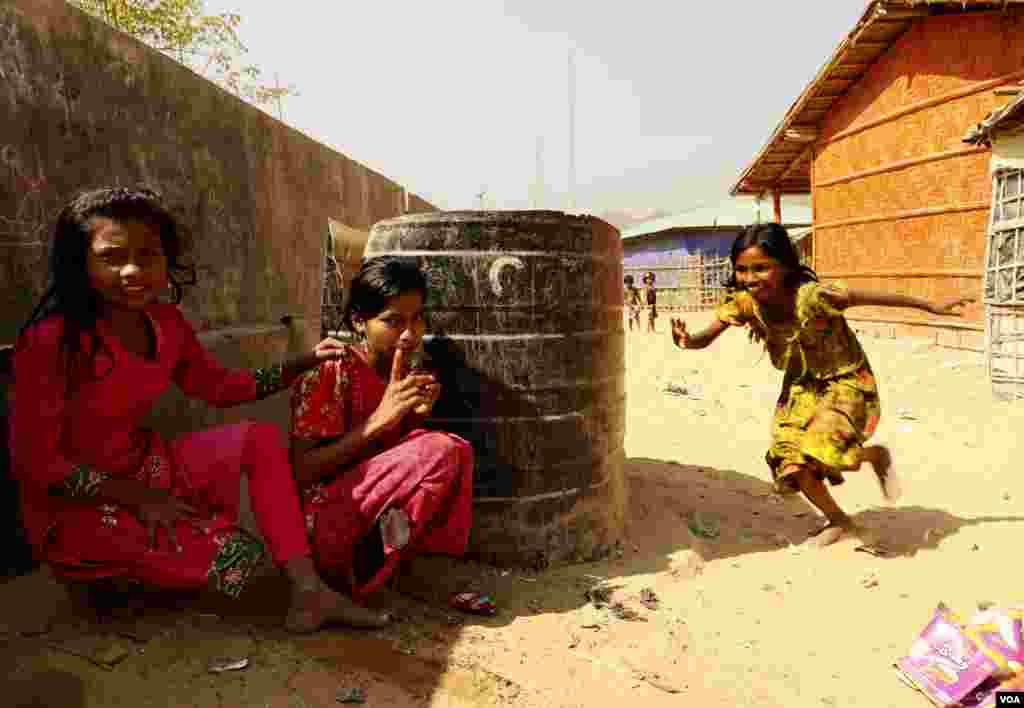 From left, Rubi Aktar, 10, Jamat Ara, 9, and Asahan, 9, play hide-and-seek at the Rohingya refugee camp in Teknaf, Bangladesh on Feb. 12, 2020. (Hai Do/VOA)
