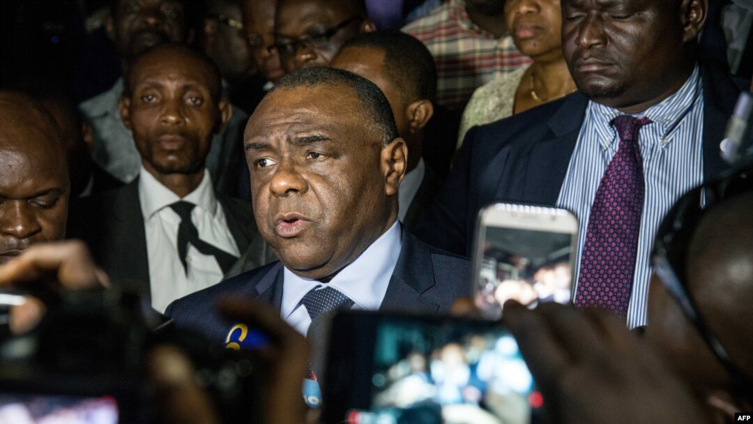 FILE - Former DRC warlord Jean-Pierre Bemba (C), speaks to the press after filing to run as a candidate in the country's next presidential election Dec. 23, at election commission offices, in Kinshasa, DRC, Aug. 02, 2018. 