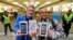 First customers of the Apple store in Oberhausen< Germany, are all smiles with their new iPhones on Sept. 20, 2013.