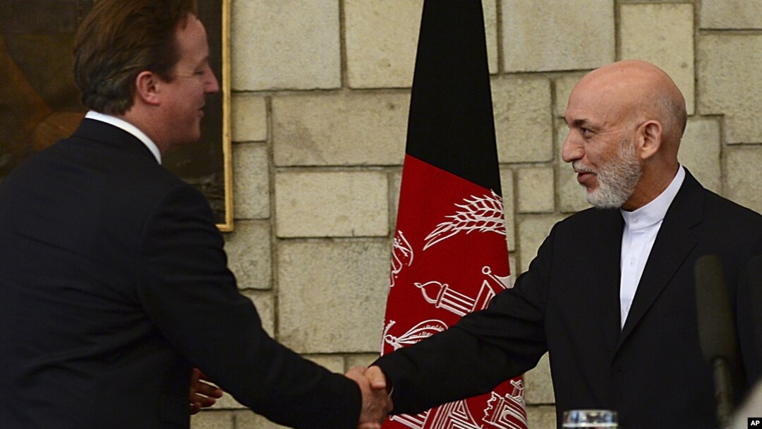 Afghan President Hamid Karzai, right, shakes hands with British Prime Minister David Cameron during a press conference at the presidential palace in Kabul, Afghanistan, June 29, 2013.