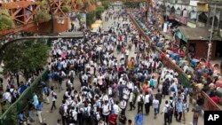 Bangladeshi students shout slogans as they blocke a road during a protest in Dhaka, Bangladesh, Aug. 1, 2018. 