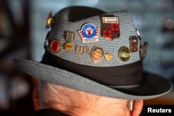 Jake Larson, a 101-year-old World War II veteran who participated in D-Day, wears a hat with pins during an interview with Reuters at his home in Martinez, California, U.S. May 20, 2024. (REUTERS/Dylan Bouscher)