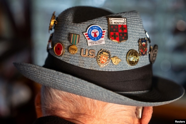 Jake Larson, a 101-year-old World War II veteran who participated in D-Day, wears a hat with pins during an interview with Reuters at his home in Martinez, California, U.S. May 20, 2024. (REUTERS/Dylan Bouscher)