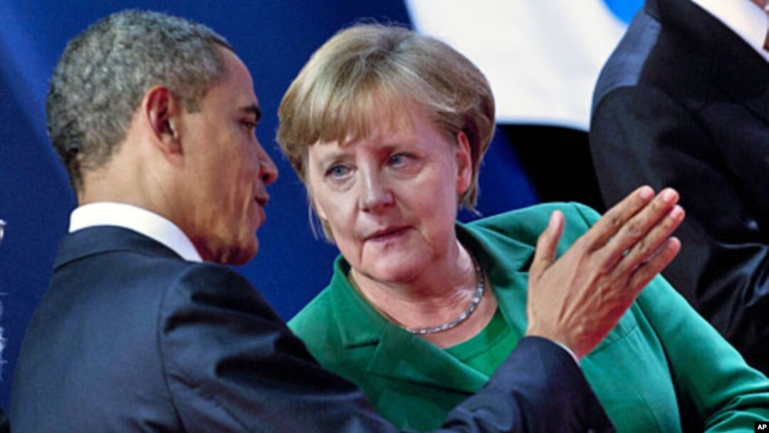 U.S. President Barack Obama and German Chancellor Angela Merkel talk at the G20 summit in Cannes, France, November 3, 2011