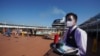 FILE - A waiter, wearing a mask for COVID-19 protection, holds a tray of drinks on the MSC Grandiosa cruise ship in Civitavecchia, near Rome, March 31, 2021.