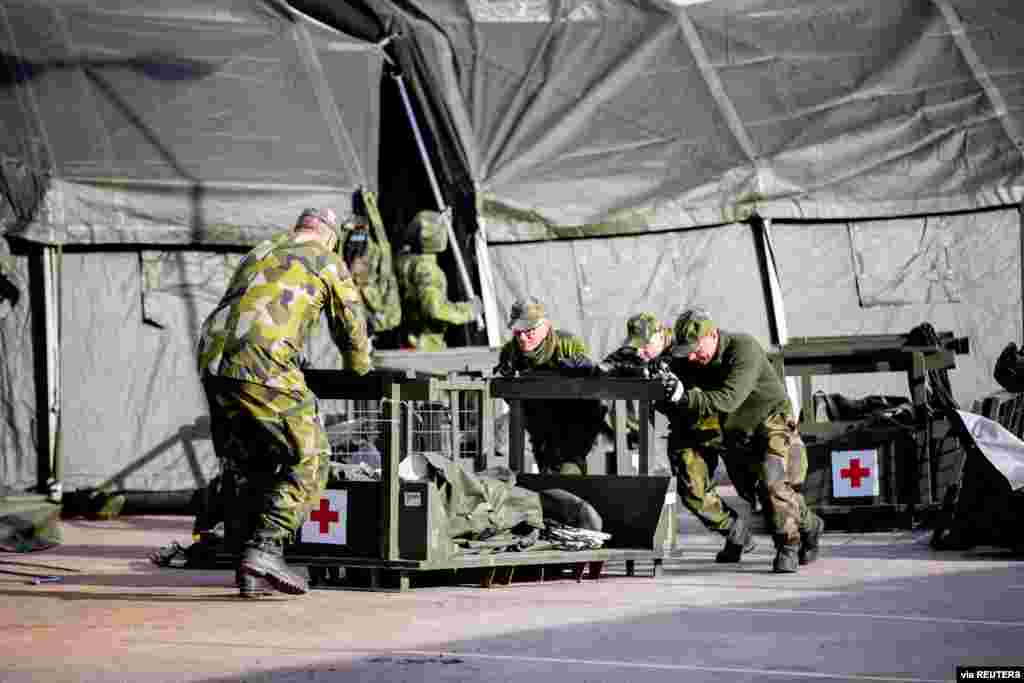 Military personnel work at a military field hospital as the spread of coronavirus disease (COVID-19) continues, at the Ostra Sjukhuset hospital area in Gothenburg, Sweden.