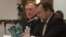 Attorney Tim Johnson, left, and Jerry Canducci, right, Transocean ISM manager, read a ISM Code booklet at the request of the hearing panel at the sixth session of BP oil spill hearings in Houston, December 9, 2010.
