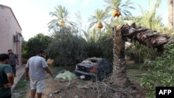 Libyans gather at the site of where a mortar shell landed in the capital Tripoli, Aug. 30, 2018.