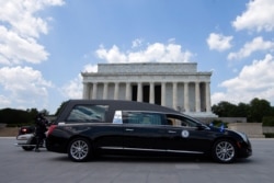 A hearse with the flag-draped casket of Rep. John Lewis, D-Ga., pauses in front of the Lincoln Memorial in Washington, on way to the Capitol, July 27, 2020.