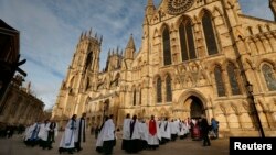 Members of the clergy enter York Minster before a service to consecrate Reverend Libby Lane as the first female bishop in the Church of England, in York, northern England, Jan. 26, 2015.