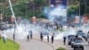 FILE - Nigerian security forces lob teargas canisters to disperse demonstrators gathered for the second day to protest against bad governance and economic hardship in Abuja, Aug. 2, 2024.