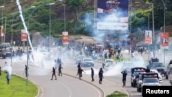 FILE - Nigerian security forces lob teargas canisters to disperse demonstrators gathered for the second day to protest against bad governance and economic hardship in Abuja, Aug. 2, 2024.