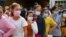 Garment factory workers and staff wait to receive China's Sinovac coronavirus disease (COVID-19) vaccine at an industrial park in Phnom Penh, Cambodia, April 7, 2021. REUTERS/Cindy Liu