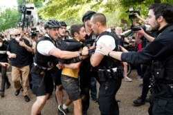 Uniformed U.S. Secret Service police detain a protester in Lafayette Park across from the White House as demonstrators protest the death of George Floyd, a black man who died in police custody in Minneapolis, May 29, 2020, in Washington.