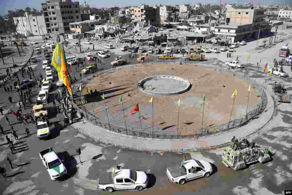 Female fighters of the Syrian Democratic Forces (SDF) gather during a celebration at the iconic Al-Naim square in Raqqa, after retaking the city from Islamic State (IS) group fighters.