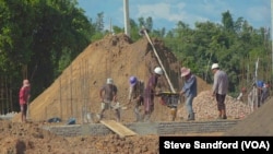 Construction workers building a condominium at the site of the Chinese resort town on the outskirts of Shwe Koko in Karen state, Myanmar.