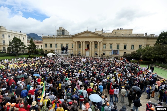 People listen as Colombia's President Gustavo Petro, flanked by First Lady Veronica Alcocer, delivers a statement about reforms that his government wants to carry out, during the May Day in Bogota, Colombia May 1, 2023. (REUTERS/Luisa Gonzalez)