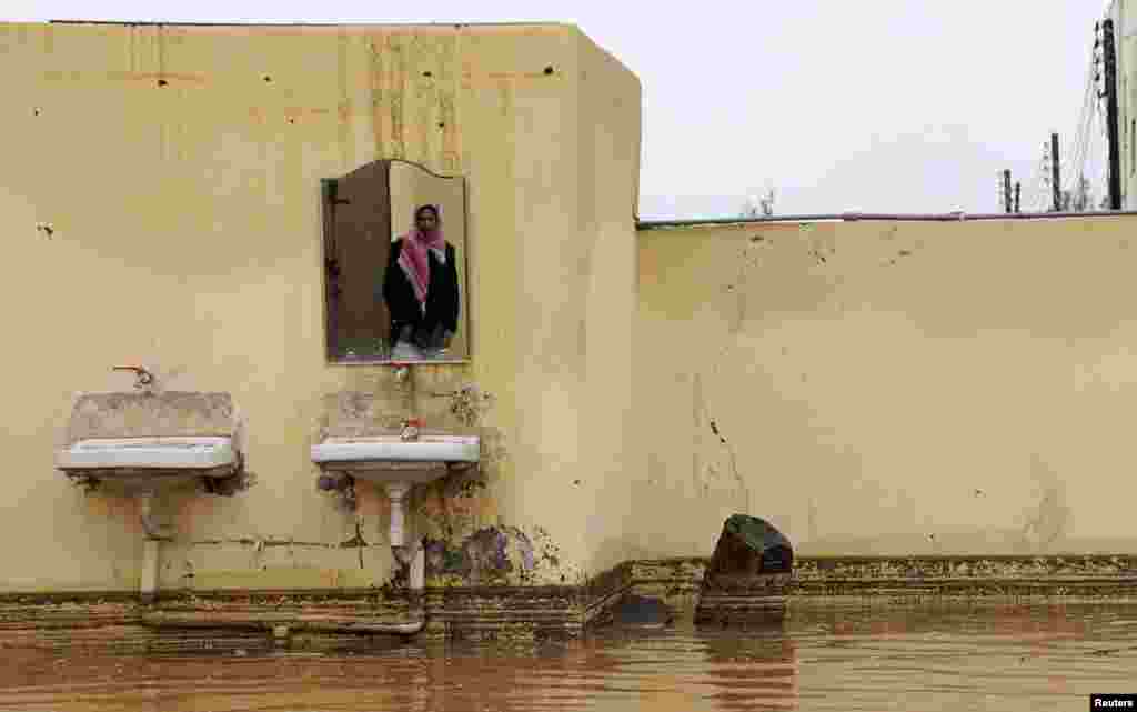 A Saudi man is reflected in a mirror in his flooded home after heavy rain in Tabuk, 1500 km (932 miles) from Riyadh, Saudi Arabia.