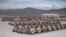 File -- U.S. Army military vehicles are readied for shipment as part of a troops drawdown at Kandahar Air Field south of Kabul, Afghanistan, on May 24, 2012.
