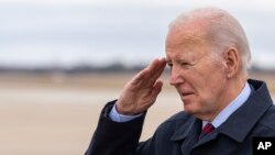 FILE— President Joe Biden salutes as he steps off Air Force One upon arrival, Tuesday, March 5, 2024, at Andrews Air Force Base, Maryland. Biden is returning from a trip to Camp David. 