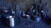 Afghan laborers polish metal pots at an aluminum factory in Herat.