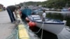 Fisherman Ron Bidgood, helps tie up and secure boats in Petty Harbour-Maddox Cove as Hurricane Larry approaches Newfoundland, Canada on Sept. 10, 2021.