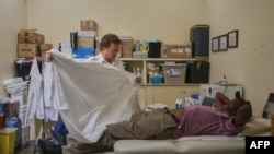 FILE — The Medical Director of Karanda Mission Hospital Dr. Paul Thistle prepares to examine a patient in his surgery rooms at the hospital in Mount Darwin on March 2, 2024.