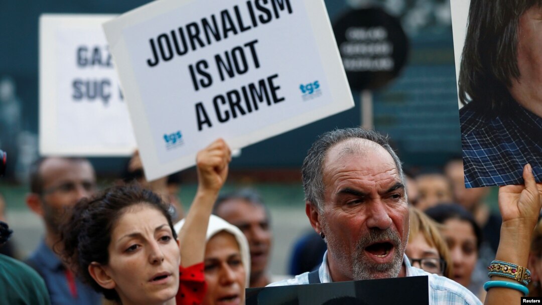 FILE - Demonstrators shout slogans during a protest against the arrest of three prominent activists for press freedom, in Istanbul, Turkey, June 21, 2016.