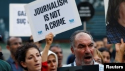 FILE - Demonstrators shout slogans during a protest against the arrest of three prominent activists for press freedom, in Istanbul, Turkey, June 21, 2016.