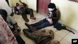 Victims await treatment after a bomb blast that ripped through the United Nations offices in the Nigerian capital of Abuja. The blast ripped through the offices as a car rammed into the building, and witnesses said they had seen a number of dead bodies be