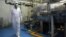 FILE - An Iranian technician walks through the Uranium Conversion Facility in Iran in February 2007. 