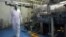 FILE - In this Feb. 2007 file photo, an Iranian technician walks through the Uranium Conversion Facility just outside the city of Isfahan, south of the capital Tehran. 