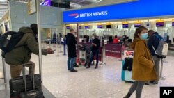 British travelers returning to their homes in Spain wait to speak to airline staff after they were refused entry onto planes, at London's Heathrow airport on Jan. 2, 2021. 